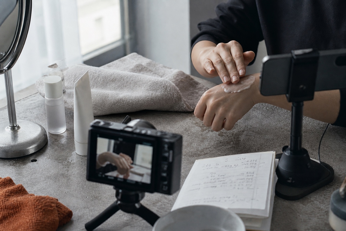 A creator records a skincare demonstration in natural light